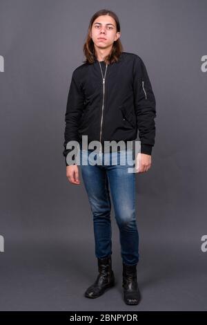 Young handsome androgynous man with long hair Stock Photo