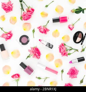 Floral composition with roses flowers and feminine make up cosmetics on white background. Flat lay, top view. Stock Photo