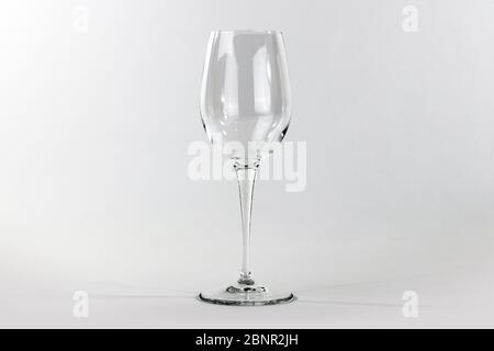 Glass flute in empty glass on white background Stock Photo
