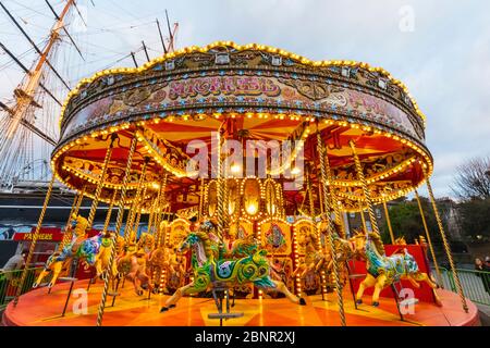England, London, Greenwich, Fairground Carousel in front of the Cutty Sark Stock Photo
