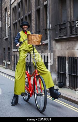 England, London, Annual New Years Day Parade, Stilt Walker Riding Giant Bicycle Stock Photo