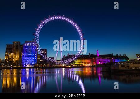 England, London, London Eye and County Hall Building at Night Stock Photo
