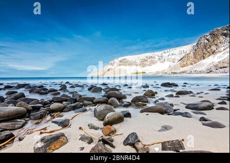 round cut stones on the sandy beach Stock Photo