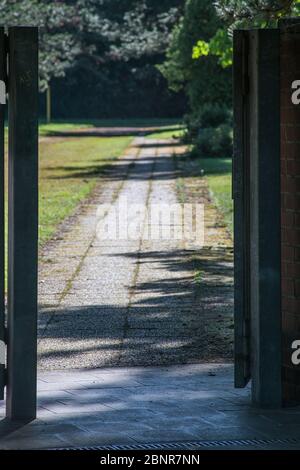 View through a gate onto a footpath that disappears into blurring. A spring scene. Stock Photo