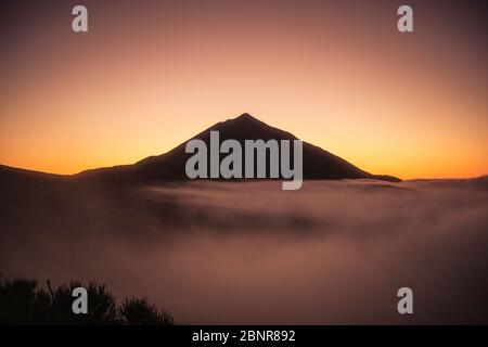 Beautiful view landscape of sunset or sunrise of el teide vulcan with clouds and foreground nature Stock Photo