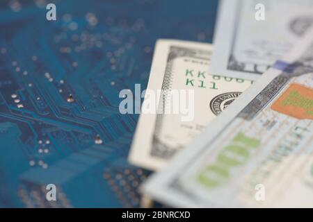 Business money dollar on PCB circuit board technology. Business concept of world digital money and remote job. Selective focus Stock Photo