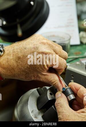 Jewelry production. The process of fixing stones with a fixer, using a microscope. Jewelry making Stock Photo