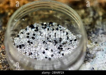 Brilliant white and black diamond in a special box for tacking Stock Photo