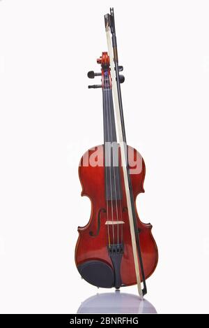 Violin with bow isolated on a white background. Musical concept. Stock Photo