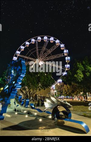 The Reef Eye ferris wheel ride attraction and the spectacular art work installation on the esplanade in Cairns, Queensland, Australia. Stock Photo