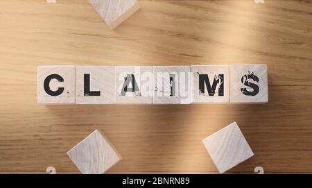 Claims word from wooden blocks on desk. Insurance business concept Stock Photo