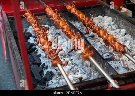 Roasted birds in food market Stock Photo