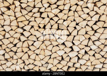 Precisely layered pile of wood from different cut firewood, heating material, sustainable reforestation Stock Photo