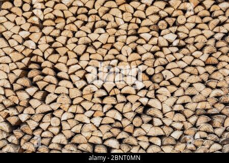 Precisely layered pile of wood from different cut firewood, heating material, sustainable reforestation Stock Photo