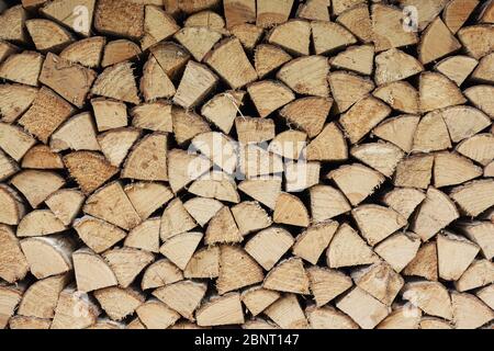 Precisely layered pile of wood from different cut firewood, heating material, sustainable reforestation Stock Photo