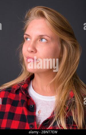Face of young beautiful hipster woman with blond hair thinking Stock Photo