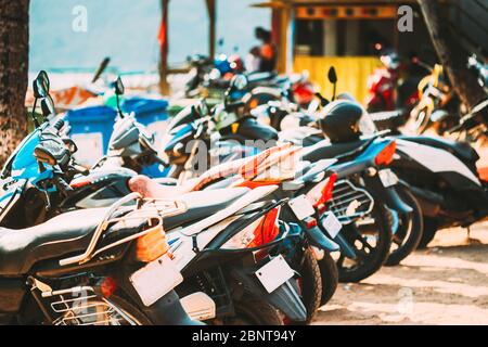 Motorbikes, motorcycles scooters parked in row in city street. Close up of details. Bikes. Stock Photo