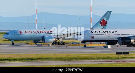 Richmond, British Columbia, Canada. 15th May, 2020. Air Canada Boeing 777 jets parked at Vancouver International Airport on May 15, 2020, the day Air Canada announced their decision to lay off approximately 20,000 employees in June. Credit: Bayne Stanley/ZUMA Wire/Alamy Live News Stock Photo