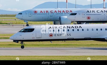 Richmond, British Columbia, Canada. 15th May, 2020. Air Canada jets at Vancouver International Airport on May 15, 2020, the day Air Canada announced their decision to lay off approximately 20,000 employees in June. Credit: Bayne Stanley/ZUMA Wire/Alamy Live News Stock Photo
