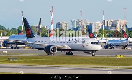 Richmond, British Columbia, Canada. 15th May, 2020. Air Canada jets at Vancouver International Airport on May 15, 2020, the day Air Canada announced their decision to lay off approximately 20,000 employees in June. Credit: Bayne Stanley/ZUMA Wire/Alamy Live News Stock Photo