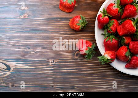 Fresh strawberries on old wooden background Stock Photo