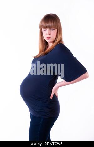 A young pregnant woman with backache. Stock Photo