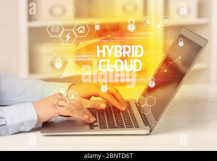 HYBRID CLOUD inscription on laptop, internet security and data protection concept, blockchain and cybersecurity Stock Photo