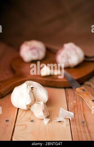 Garlic cloves and garlic bulb on a white wooden table Stock Photo