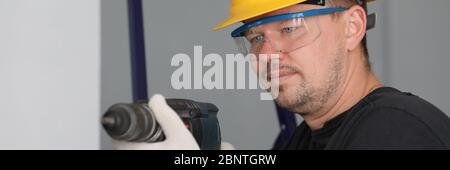 Man in protective helmet and eyewear Stock Photo