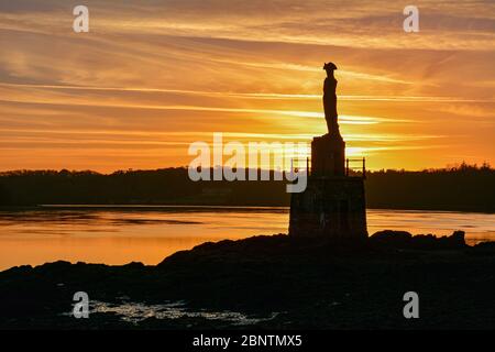 Anglesey sunset over Nelsons statue on the shores of the Menai Strait Stock Photo