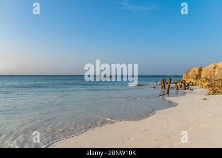 Zanzibar, Tanzania - February 8. 2020: Sunset time at the beach of Nungwi with people walking around, copy space for text Stock Photo