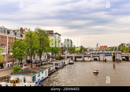 AMSTERDAM, HOLLAND – AUG. 31, 2019: Amsterdam, capital of the Netherlands, has more than one hundred kilometers of canals, 90 islands & 1,500 brigges. Stock Photo