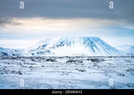 Mountainous Icelandic volcanic wilderness near Lake Myvatn. Winter snow covered lanscape Stock Photo