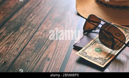 Items for summer vacation: a camera, passport,smartphone, money, hat, sunglasses. Wooden background, top view with Copy space. Beautiful summer concep Stock Photo
