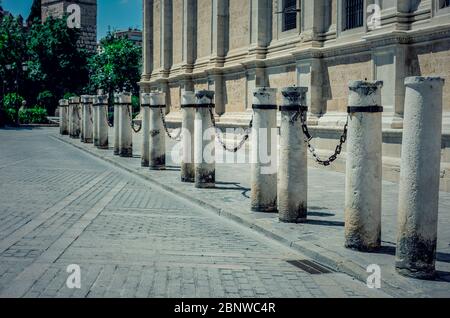 Columns and chains around the Cathedral of Seville, Andalusia, Spain during coronavirus pandemic. Empty city. No tourism. Stock Photo
