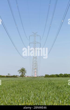 High voltage transmission line against clear blue sky Stock Photo