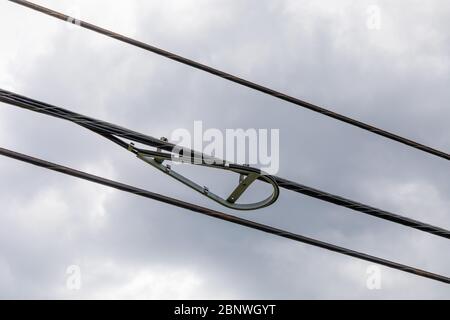 Fiber optic snowshoe along with power lines against a grey sky with heavy clouds, horizontal aspect Stock Photo
