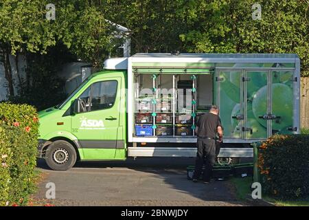 An Asda grocery delivery driver delivering to a home Stock Photo