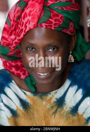 Senegalese woman poses for a picture at her fabric stall in Dakar ...