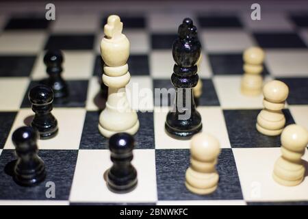 the chessboard with Black King and white King in front in the concept of agreement with arounds pawns. Stock Photo