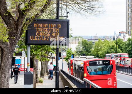 A reminder to London motorists of the reintroduction of the Congestion Charge and Low and Ultra-Low Emission Zones on Monday May 15, 2020, on a dot matrix display by the southbound A1 Archway Road into London, UK Stock Photo