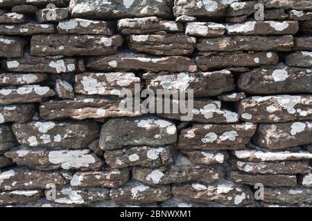 Ancient weathered dry stone wall background Stock Photo