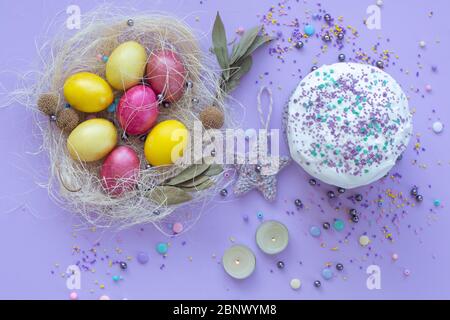 beautiful beautiful Easter composition in purple tones with painted eggs and cake Stock Photo