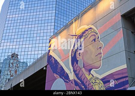 Street art on a building depicting a young Indigenous Cree woman in downtown Calgary Alberta Canada Stock Photo