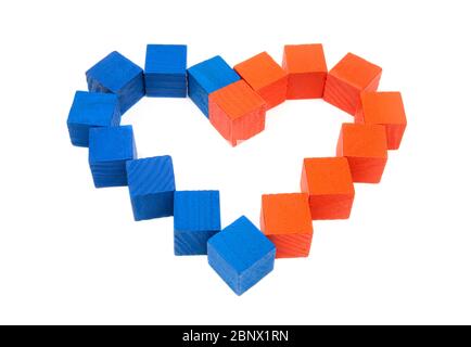 Close-up of a heart symbol made of red and blue wooden cubes on a white background. Top view, selective focus. Building healthy relationships concept. Stock Photo