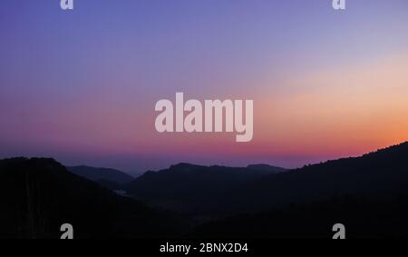 Simple , Decent and Beautiful Sunset in Twilight Hour Create Silhouette of the Mountains in the Foreground, Display Amazing Warm Color Tints, 5K Stock Photo