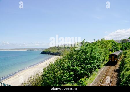 Primrose Valley Railway, single track. Train approaching St. Ives station. Stock Photo