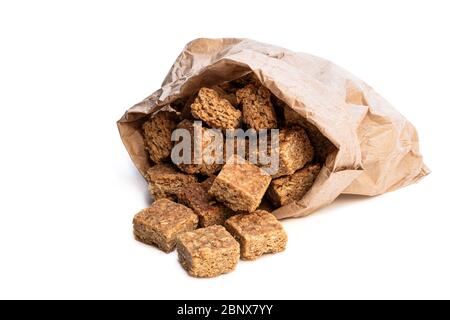 Mini  oat and syrup flapjack slices in paper bag isolated on white Stock Photo