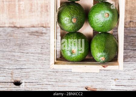 Hass avocado fruits, on wooden background, close-up Stock Photo