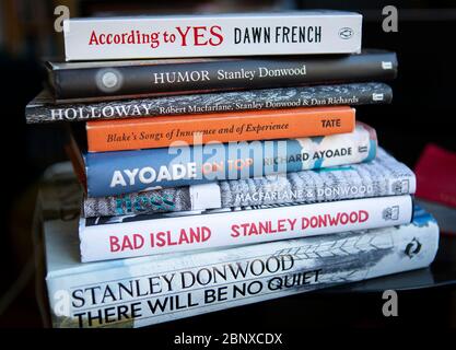 Stack of books on glass table Stock Photo